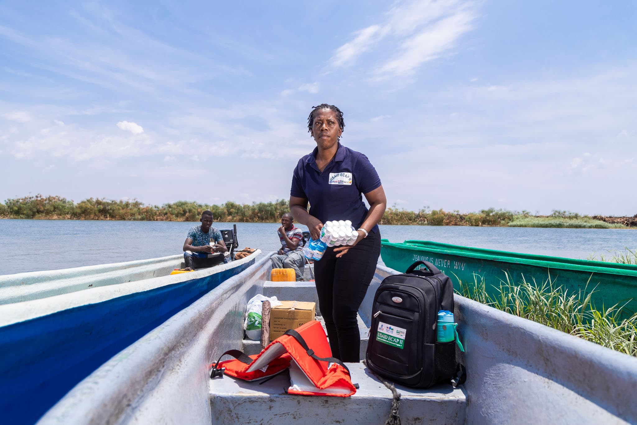 A PCZ case worker crossing water by boat to reach a remote community