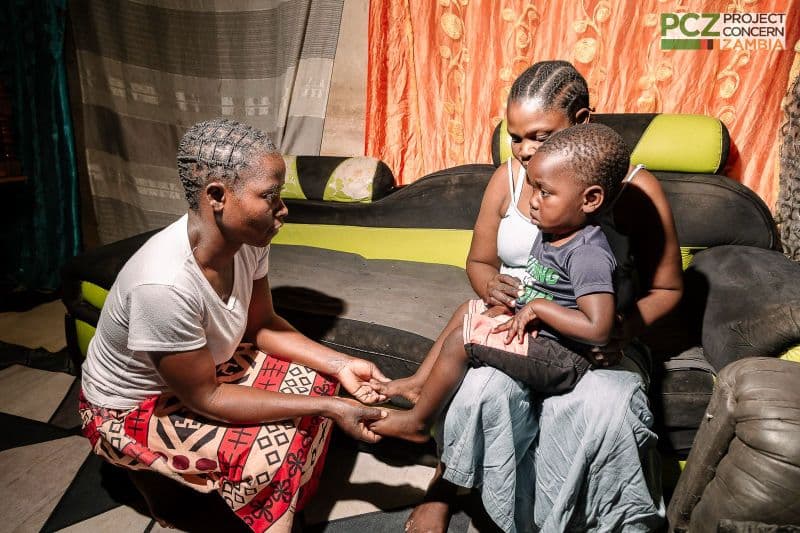 A PCZ case worker collecting point-of-care data on a home visit